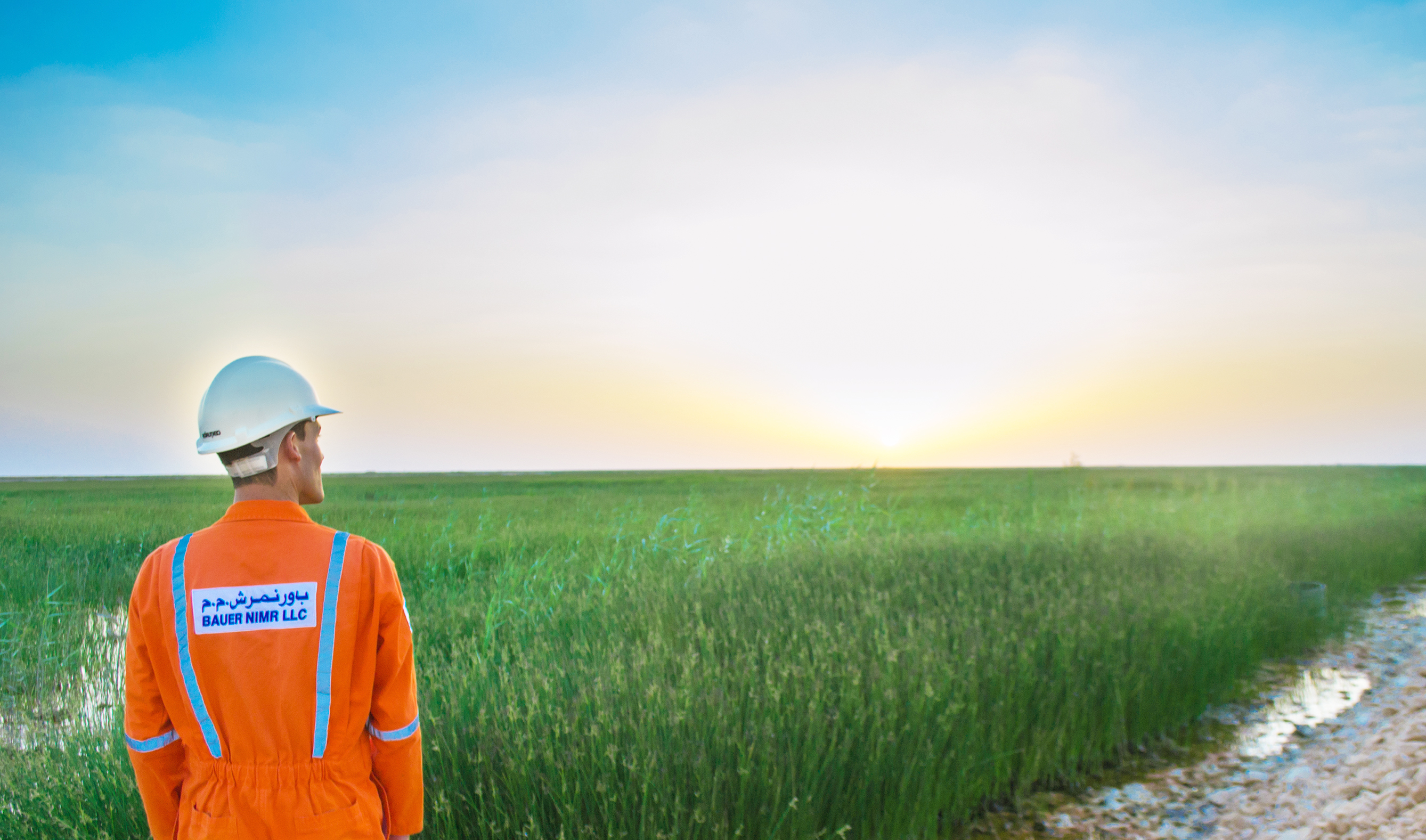 An employee of Bauer Resources at constructed wetland for wastewater treatment at nimr oman.